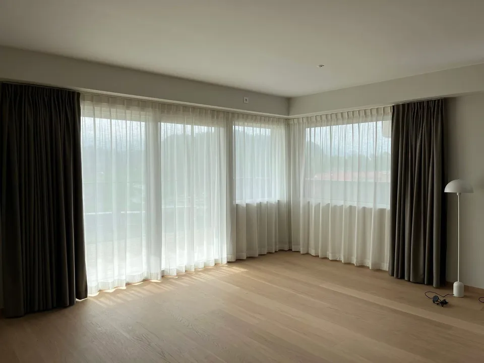 Stuehjørne med transparente gardiner og mørkleggingsgardiner